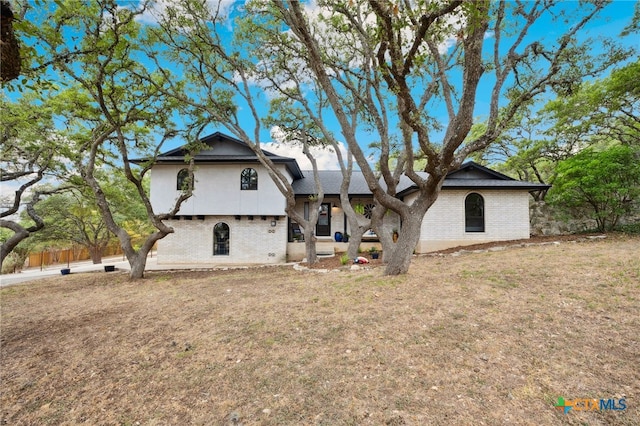 rear view of house with a yard