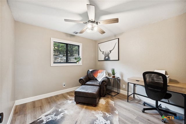 home office with light hardwood / wood-style floors and ceiling fan