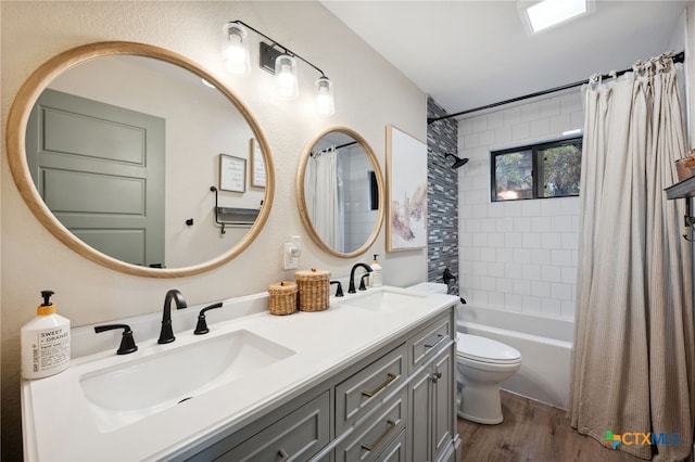 full bathroom featuring shower / bath combo with shower curtain, toilet, wood-type flooring, and vanity