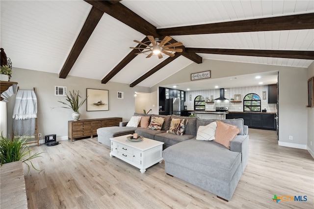 living room with vaulted ceiling with beams, ceiling fan, and light wood-type flooring