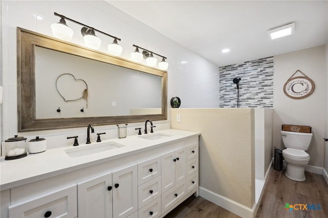 bathroom with hardwood / wood-style floors, vanity, toilet, and backsplash