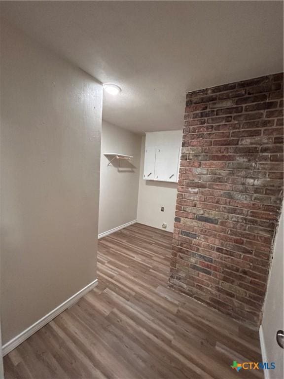 clothes washing area with hardwood / wood-style floors