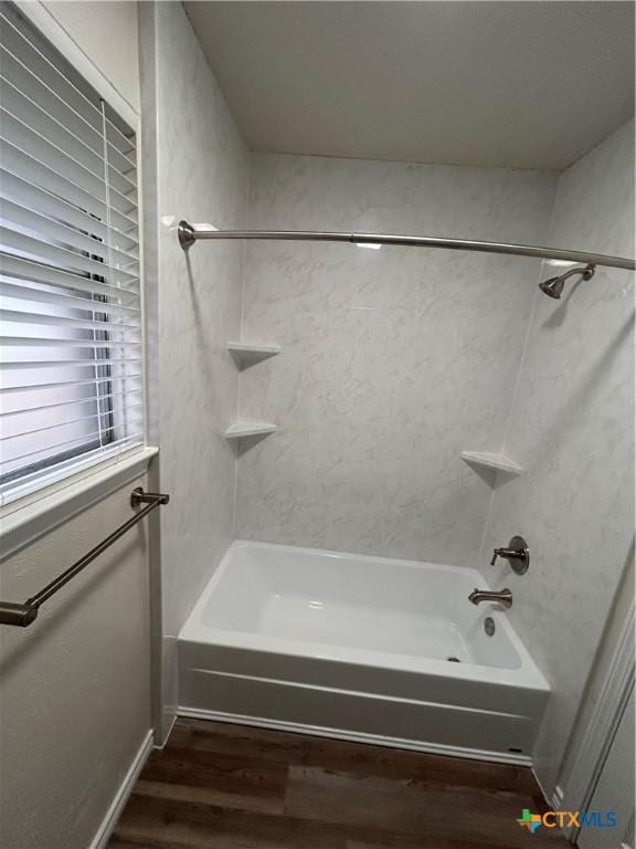 bathroom featuring hardwood / wood-style floors and tiled shower / bath