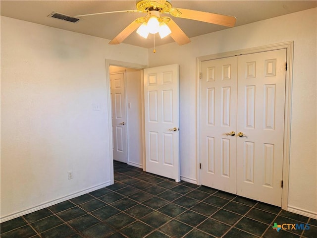 3900 Chisholm Trl, Salado, TX 76571 - unfurnished bedroom featuring a closet, ceiling fan, and dark tile patterned flooring