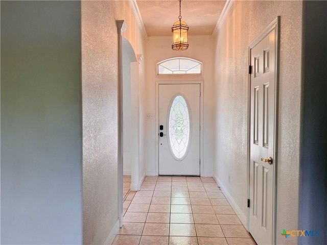 3900 Chisholm Trl, Salado, TX 76571 - entryway featuring crown molding, a textured wall, light tile patterned floors, a chandelier, and baseboards