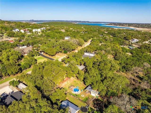 birds eye view of property featuring a water view and a forest view