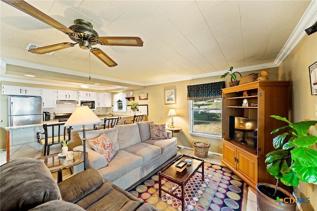 living area with ceiling fan, ornamental molding, light tile patterned flooring, and baseboards