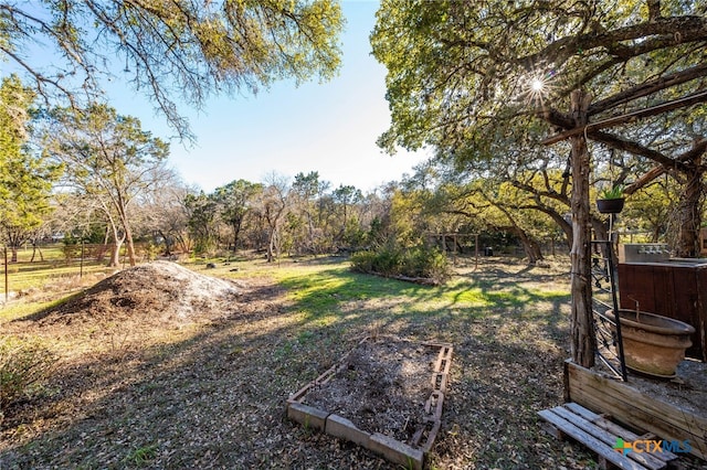 view of yard with a vegetable garden and fence