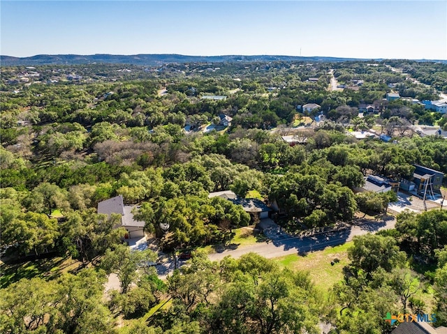 birds eye view of property featuring a forest view