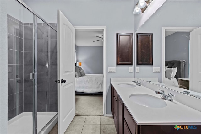 bathroom with tile patterned flooring, a stall shower, ensuite bathroom, and a sink