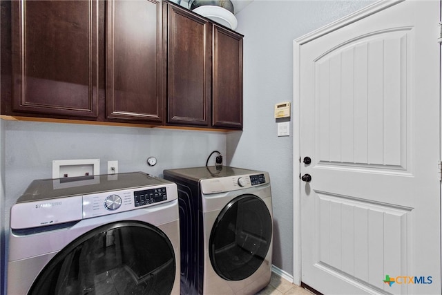 laundry area featuring cabinet space and washer and clothes dryer