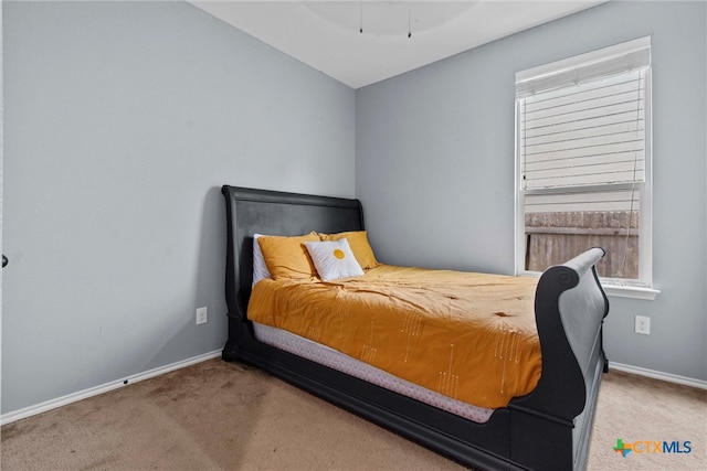 bedroom featuring carpet flooring and baseboards