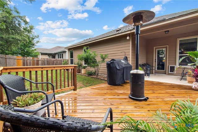 wooden deck featuring area for grilling and fence