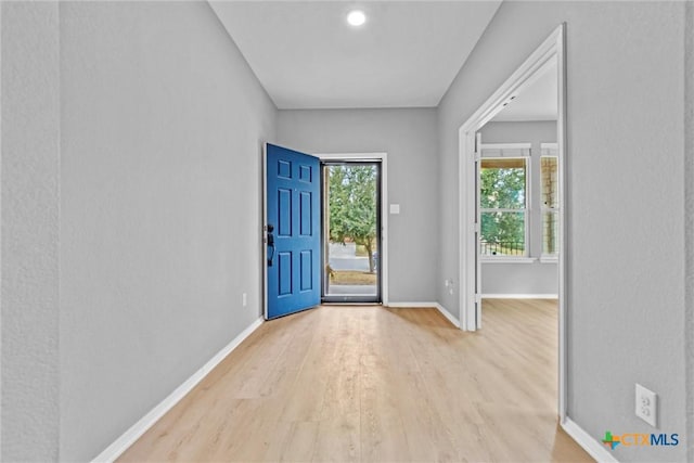 entryway featuring light wood-type flooring and baseboards