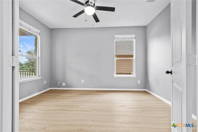 unfurnished room featuring baseboards, light wood-type flooring, and ceiling fan