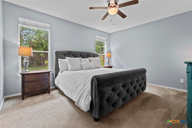 carpeted bedroom with baseboards and ceiling fan