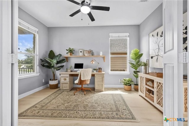 office area featuring a ceiling fan, wood finished floors, and baseboards