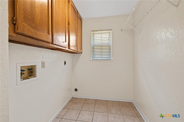 601 Pondview Dr, Killeen, TX 76542 - laundry room with cabinet space, hookup for an electric dryer, hookup for a washing machine, and light tile patterned flooring
