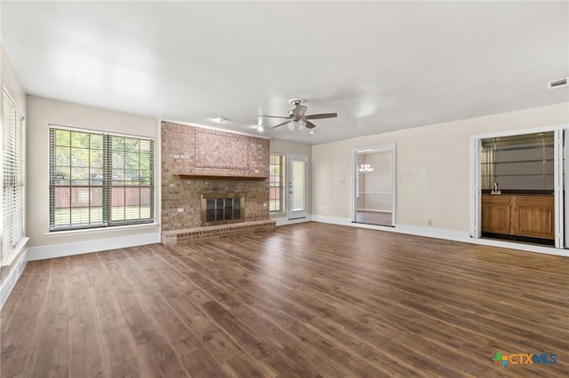 601 Pondview Dr, Killeen, TX 76542 - unfurnished living room with dark wood-style floors, a ceiling fan, and healthy amount of natural light