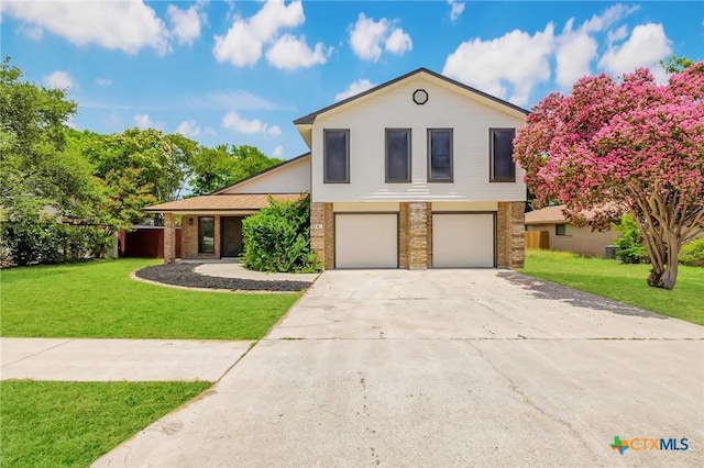 601 Pondview Dr, Killeen, TX 76542 - view of front of home featuring a garage, driveway, a front lawn, and brick siding