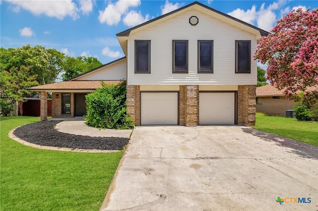 601 Pondview Dr, Killeen, TX 76542 - view of front of home featuring an attached garage, a front yard, concrete driveway, and brick siding