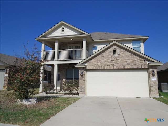 view of front of property featuring a balcony, a garage, concrete driveway, and brick siding