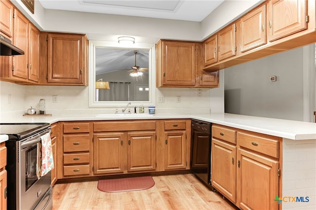 kitchen with stainless steel electric range, kitchen peninsula, sink, light hardwood / wood-style flooring, and decorative light fixtures