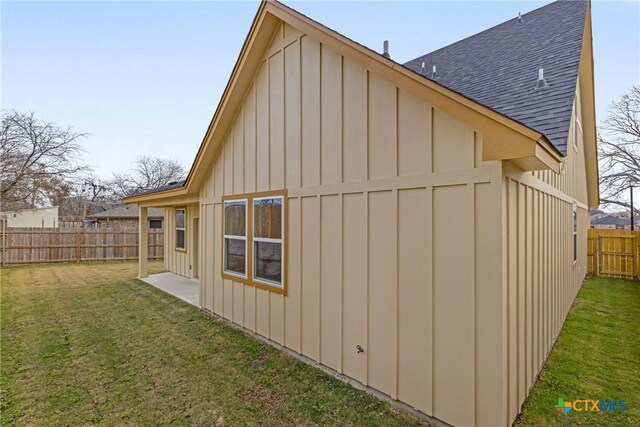 2143 Blackhawk Loop, Belton, TX 76513 - view of property exterior featuring roof with shingles, board and batten siding, and a fenced backyard