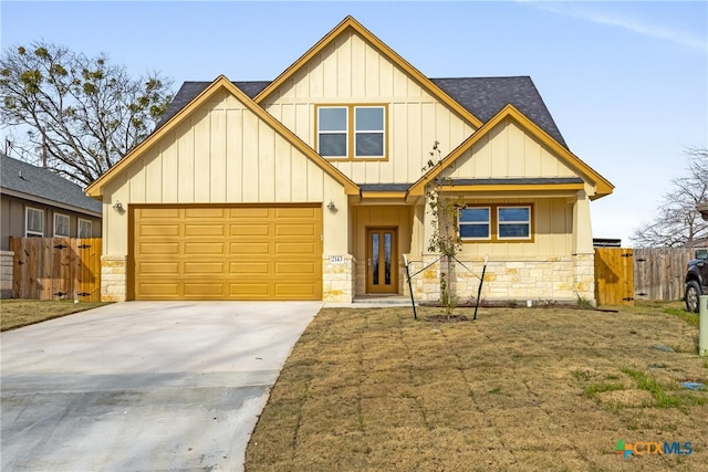 view of front of house featuring a garage and a front lawn