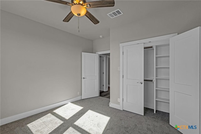 unfurnished bedroom featuring ceiling fan, a closet, and carpet flooring