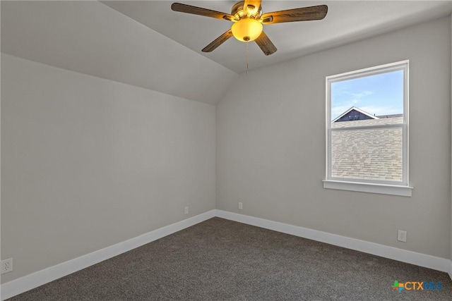 additional living space with ceiling fan, dark carpet, and vaulted ceiling