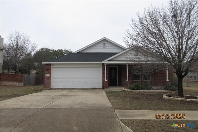 ranch-style home featuring a garage, fence, concrete driveway, and brick siding