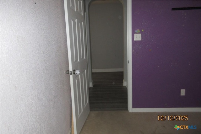 hallway featuring baseboards