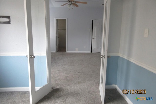 hall featuring light carpet and baseboards