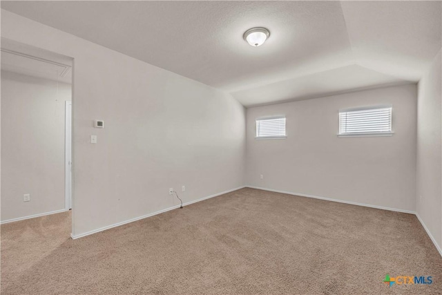 6106 Amelia Earhart Blvd, Killeen, TX 76543 - carpeted spare room with attic access, baseboards, and vaulted ceiling