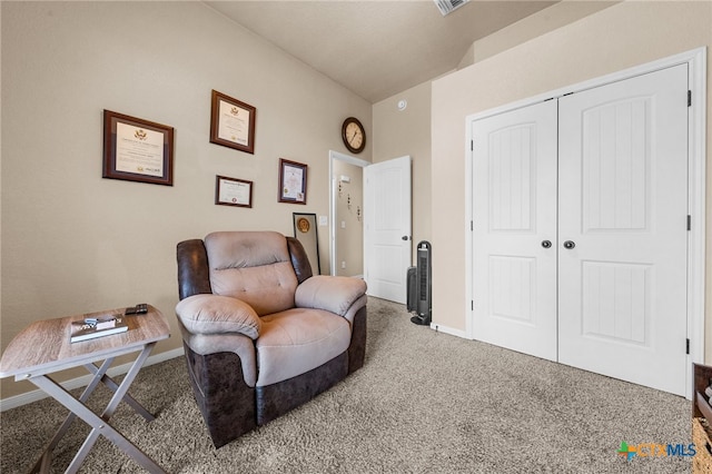 sitting room with vaulted ceiling and carpet floors