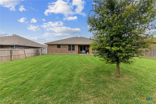 rear view of house with a lawn