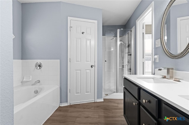 5300 Two Step Pl, Killeen, TX 76542 - full bath featuring a bath, a stall shower, double vanity, and wood finished floors