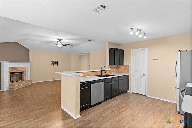 5300 Two Step Pl, Killeen, TX 76542 - kitchen with stainless steel appliances, a sink, a peninsula, open floor plan, and light wood-style floors
