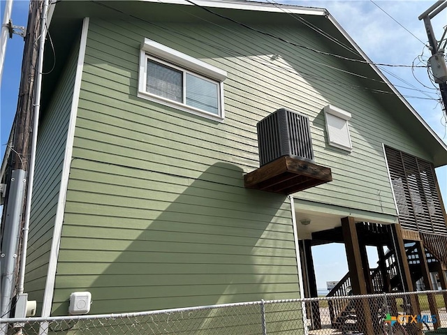 view of home's exterior with fence