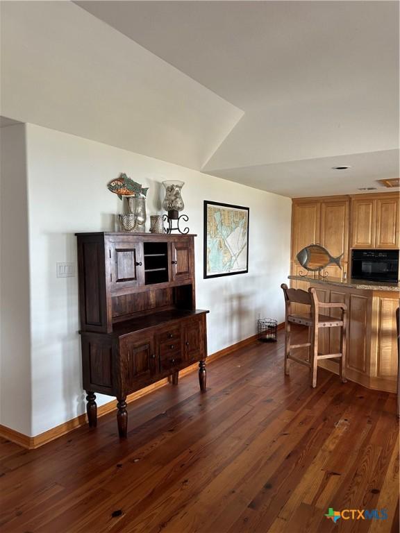 interior space featuring dark wood finished floors and baseboards