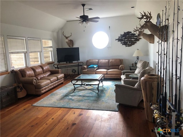 living room with visible vents, wood-type flooring, ceiling fan, and vaulted ceiling