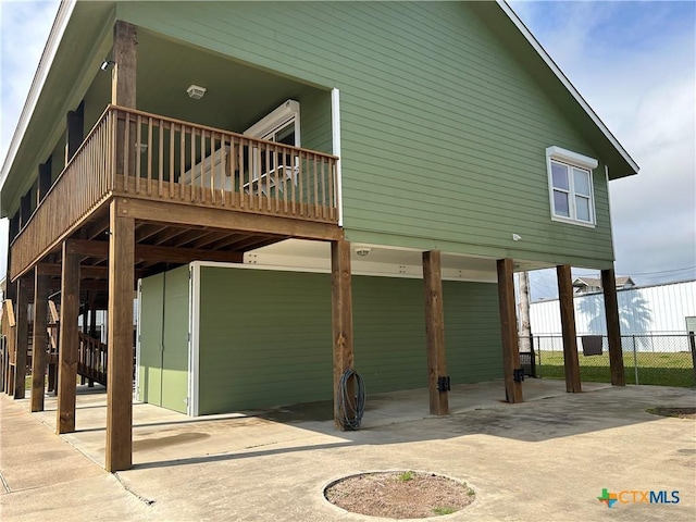 exterior space with a carport, driveway, and fence