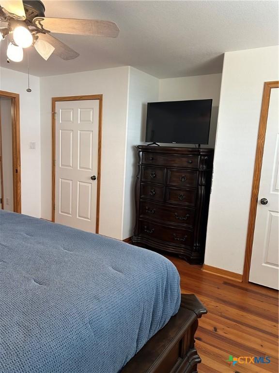 bedroom featuring hardwood / wood-style floors and ceiling fan