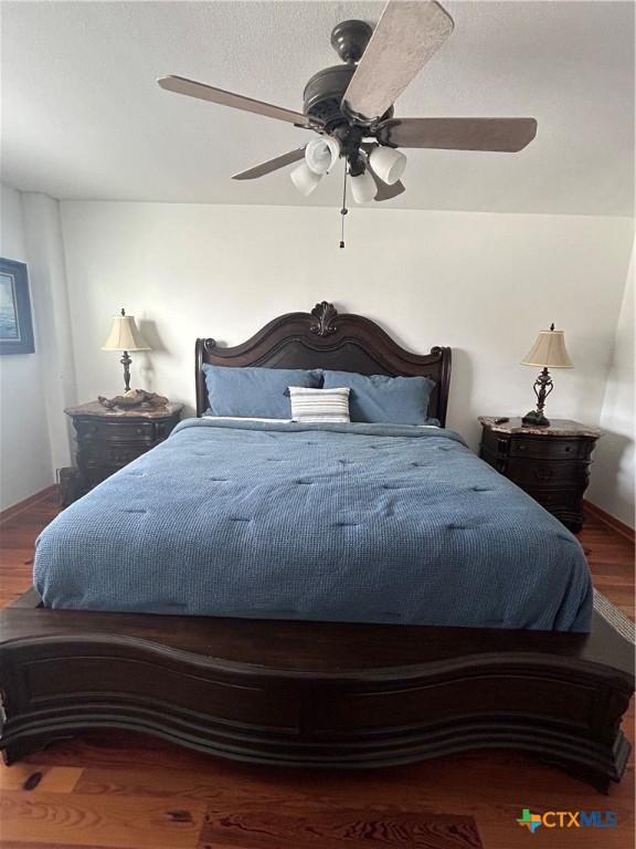 bedroom with wood finished floors and a ceiling fan