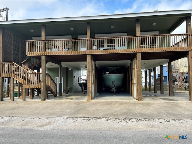 rear view of house with a carport and stairway