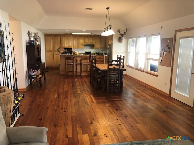 dining area featuring visible vents, baseboards, dark wood-style floors, and vaulted ceiling