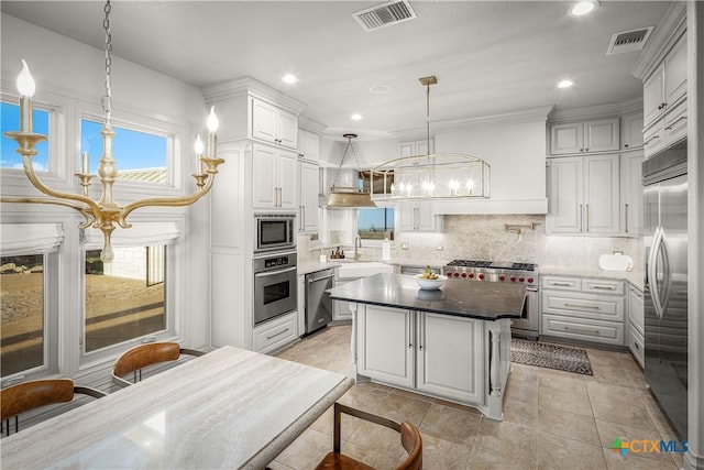 111 Western Oaks, New Braunfels, TX 78132 - kitchen featuring built in appliances, visible vents, backsplash, and an inviting chandelier