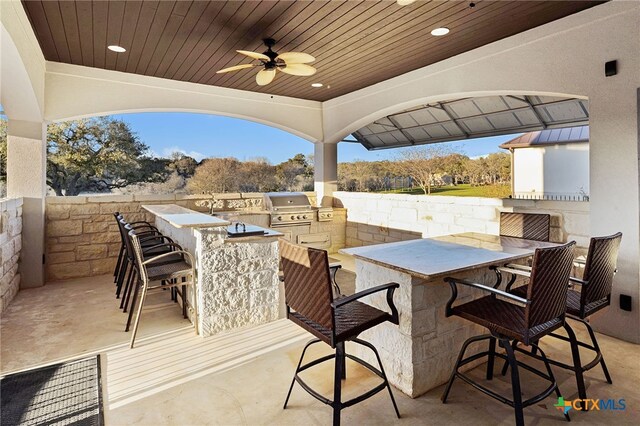 111 Western Oaks, New Braunfels, TX 78132 - view of patio featuring outdoor wet bar, ceiling fan, grilling area, and an outdoor kitchen