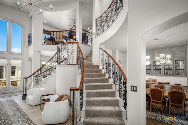111 Western Oaks, New Braunfels, TX 78132 - staircase featuring visible vents, a high ceiling, and ceiling fan with notable chandelier